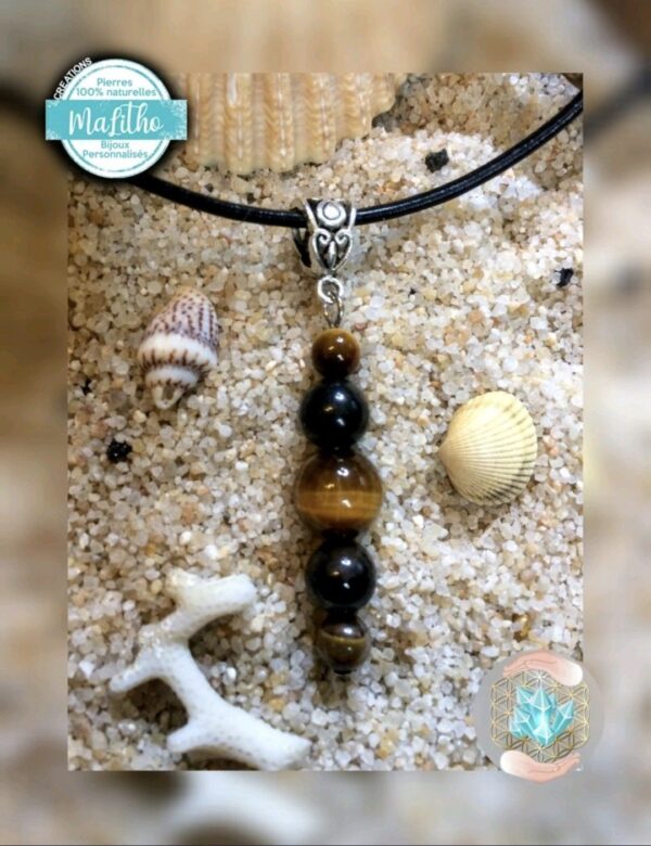 Pendentif  avec cordon noir réglable (coton ciré très solide) en OEIL DE TIGRE et SPINELLE NOIRE Création ''MALITHO'' de chez Bijoux, pierres et bien-être à Albert.